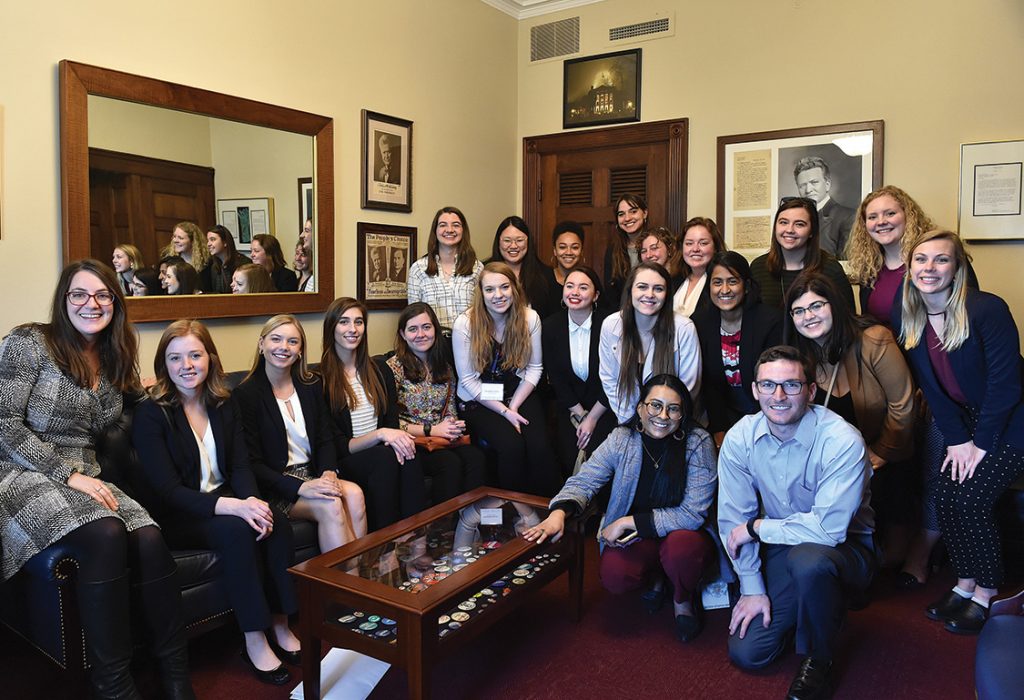 group of activists gathered for a group shot in a congressional office