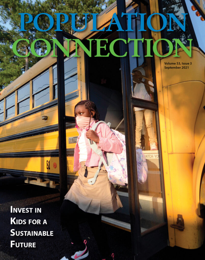 a masked black child walking out of a school bus to the first day of school.
