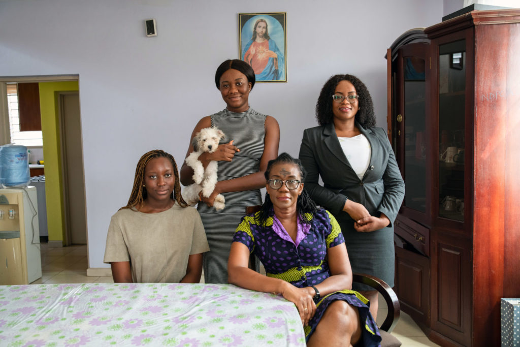 Portrait of Dr. Leticia Adelaide Appiah with her 3 grown daughters at their dining room table.