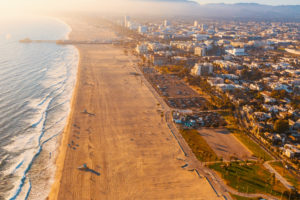 Aerial view of Santa Monica Pier and densely populated skyline, Los Angeles, USA