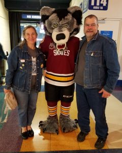 Deena Sherman stands with a Chicago Wolves hockey mascot