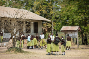 Tanzanian secondary students stand in schoolyard