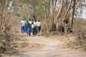 group of children in Tanzania walking to school together