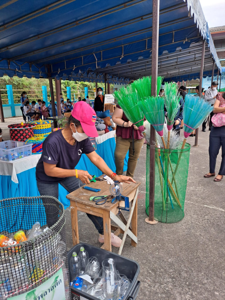 woman makes a broom out of recycled plastic