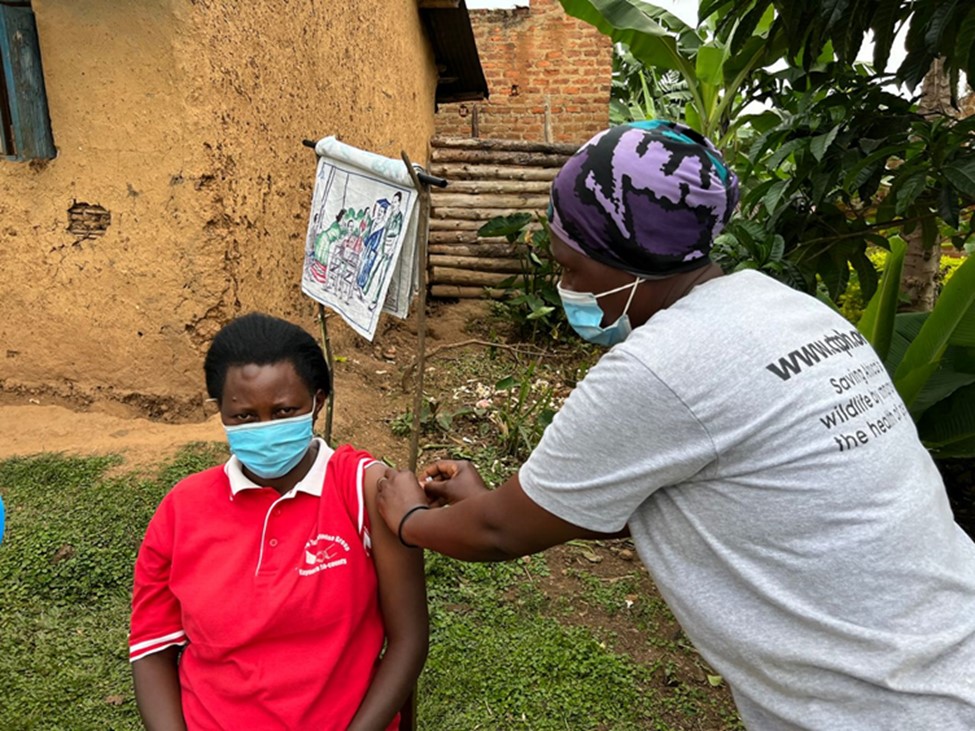 A VHCT administering a family planning method on a community member living around Bwindi Impenetrable National Park