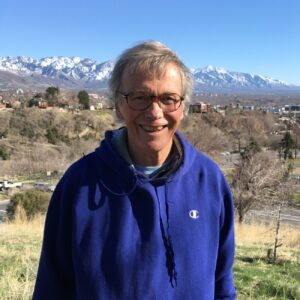 Portrait of Wayne Martinson in front of white-capped mountain range