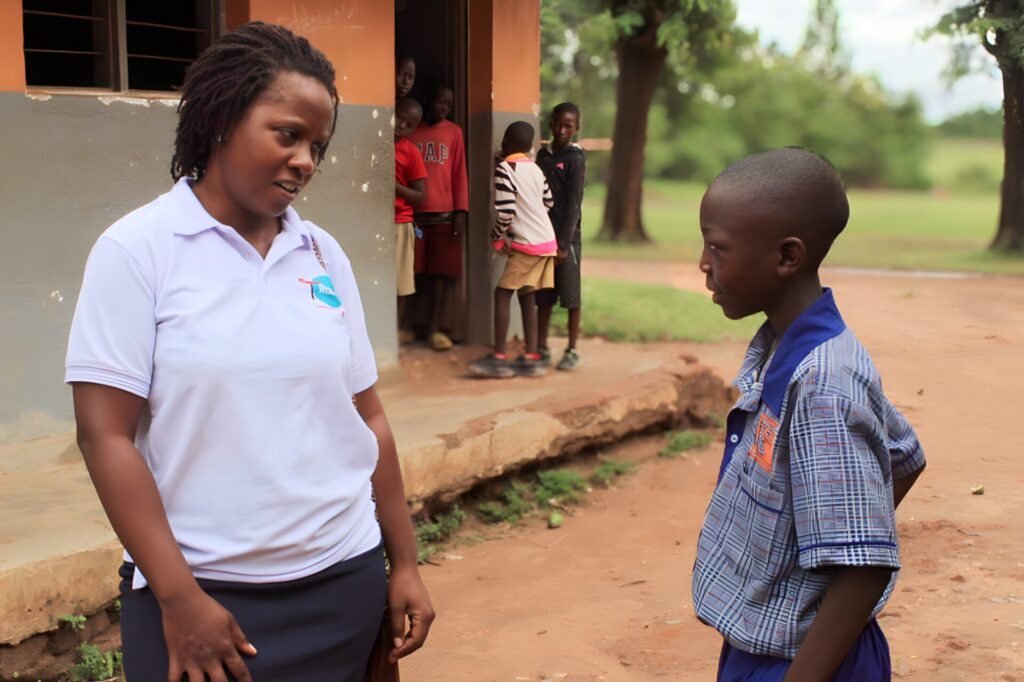 Lea Talking With A School Boy At A FlowReady Outreach
