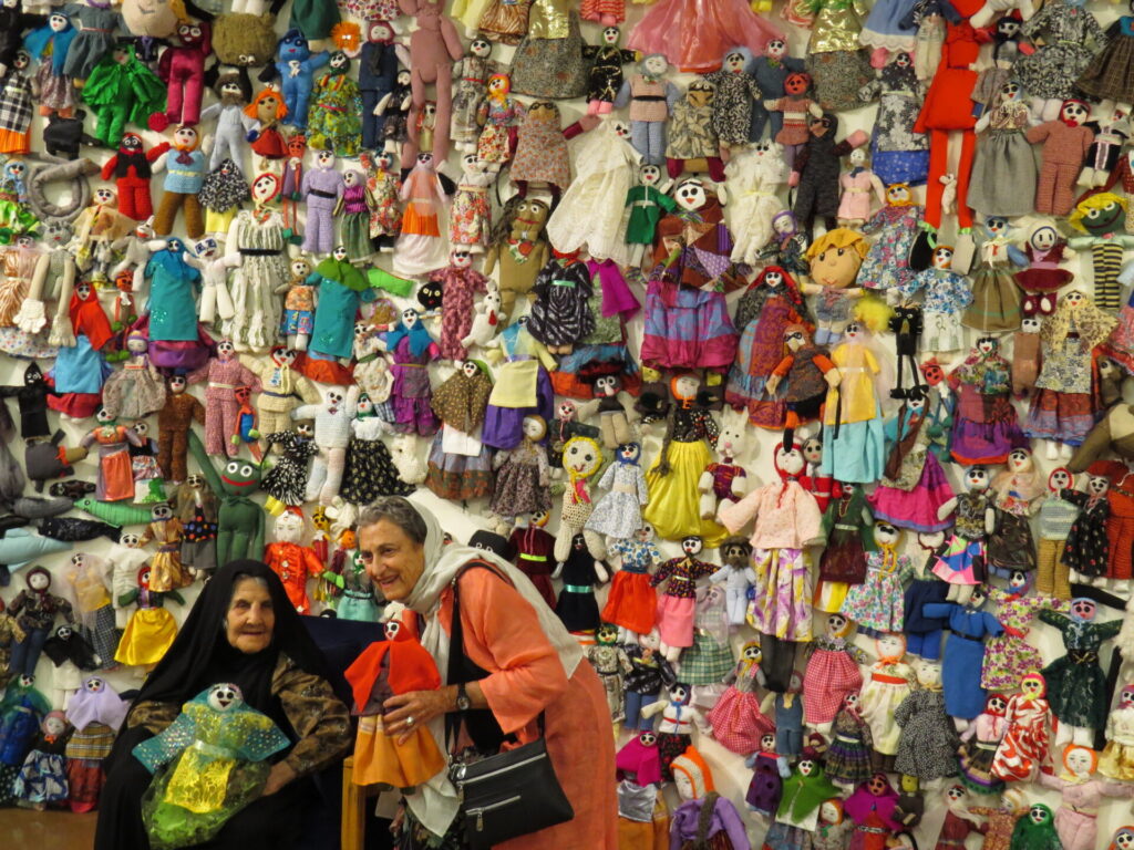 A life-time Iranian collector of dolls shows them off to an American. Submitted by: Keith Anderson