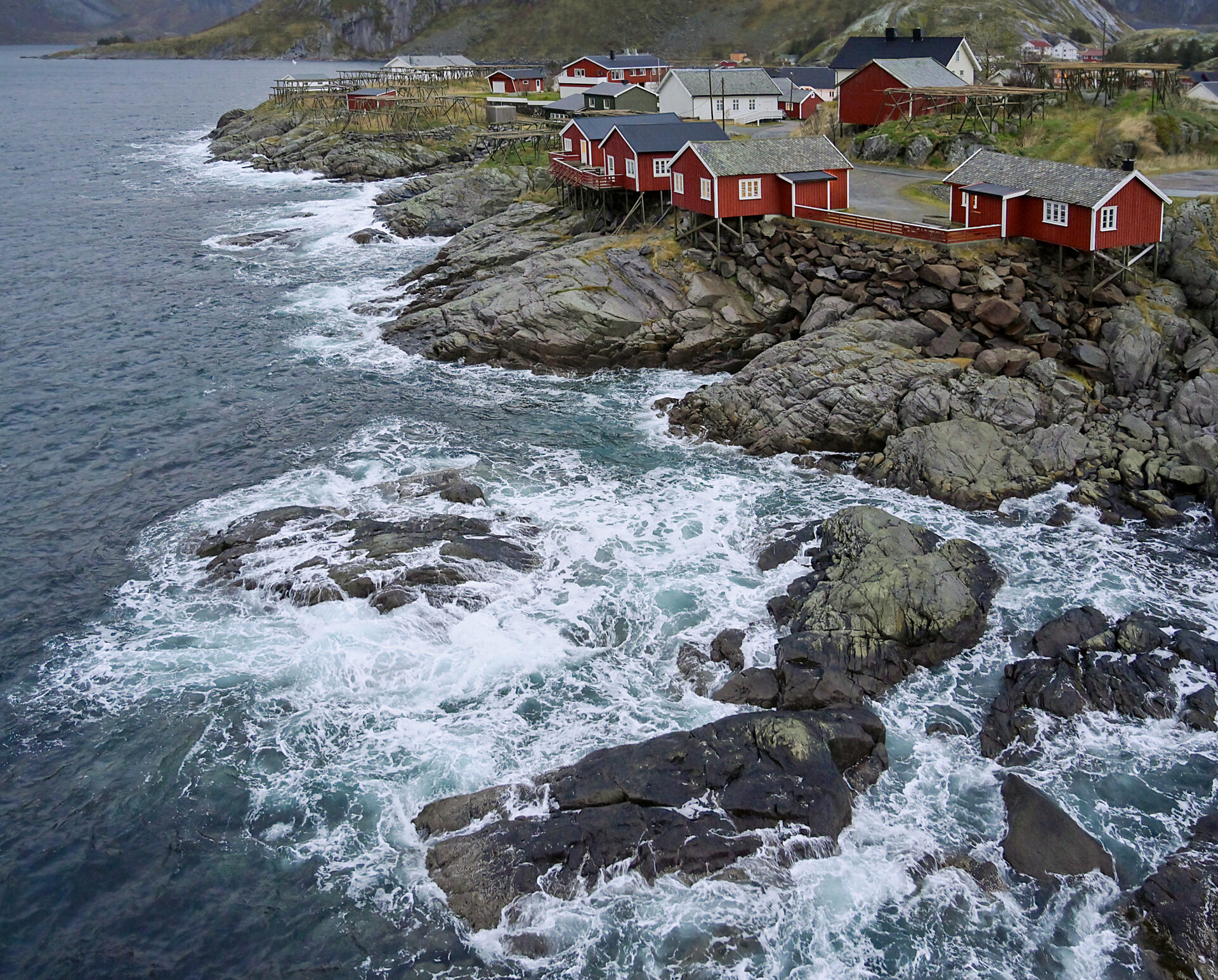 From a bridge, we look down on animated water against the rocks of Hamnoy Village in the Lofoten Islands of Norway. Submitted by: Karl Leck