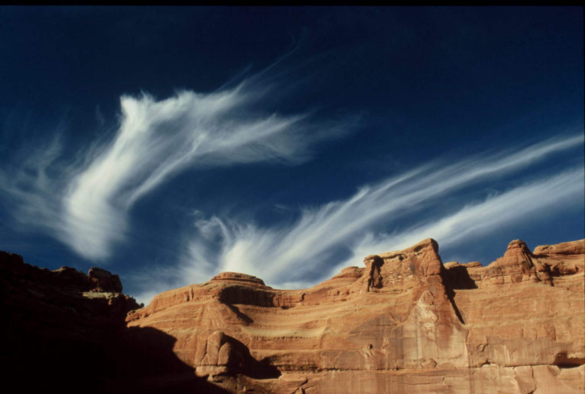 The clouds in the western sky look spectacular over the red rock! Photographed at Arches National Park in Utah. Submitted by: Leslie Scopes Anderson