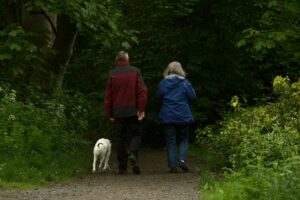 Older couple walking with dog
